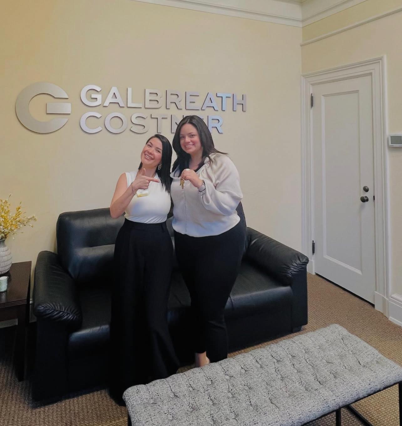 Sandy Alvear with client at Galbreath Costner law firm — keys in hand